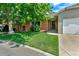 Well-kept lawn and a brick facade leading to the front door give this home great curb appeal at 1545 August Ln, Brighton, CO 80601