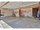 Spacious garage with ample storage and workspace, equipped with tools and sporting equipment at 1545 August Ln, Brighton, CO 80601