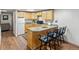 Basement kitchenette with modern appliances and a seating bar at 1545 August Ln, Brighton, CO 80601
