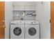 A dedicated laundry room with a modern washer and dryer set and plenty of storage at 1545 August Ln, Brighton, CO 80601