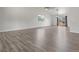 Spacious living area featuring wood-look floors, a large window, and access to the backyard at 1545 August Ln, Brighton, CO 80601