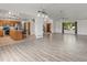 Open-concept living area boasting wood floors, modern lighting, and a kitchen with an island at 1545 August Ln, Brighton, CO 80601