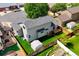 Aerial view of the home's rear exterior, showcasing the deck, fenced yard, and well-maintained lawn at 1545 August Ln, Brighton, CO 80601