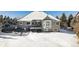 Spacious backyard with snow covered ground, deck and hot tub at 1430 Milbury St, Castle Rock, CO 80104