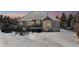 Spacious backyard with a deck, hot tub, and snowy landscape at 1430 Milbury St, Castle Rock, CO 80104