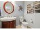 Clean bathroom with a pedestal sink, toilet and decorative accents at 1430 Milbury St, Castle Rock, CO 80104