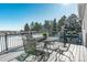 Deck with table and chairs overlooking a snowy landscape at 1430 Milbury St, Castle Rock, CO 80104