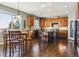 Modern kitchen with wooden cabinets, granite island and hardwood floors at 1430 Milbury St, Castle Rock, CO 80104