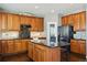 Spacious kitchen with island, granite countertops, and wood cabinets at 1430 Milbury St, Castle Rock, CO 80104