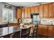 Kitchen features wood cabinets, granite countertops and island at 1430 Milbury St, Castle Rock, CO 80104