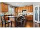 Modern kitchen with wooden cabinets, granite island and hardwood floors at 1430 Milbury St, Castle Rock, CO 80104