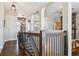 Elegant staircase with a wooden railing and hardwood floors at 1430 Milbury St, Castle Rock, CO 80104