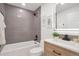 Stylish bathroom features a bathtub, a modern vanity, and neutral-toned tiles at 9306 Clermont Dr, Thornton, CO 80229