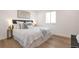 Serene bedroom with a plush bed, stylish décor, and ample natural light from the window at 9306 Clermont Dr, Thornton, CO 80229