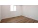 This room features hardwood floors, a window, and white walls at 9306 Clermont Dr, Thornton, CO 80229