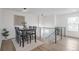 Modern dining room features contemporary lighting, a staircase, and neutral décor at 9306 Clermont Dr, Thornton, CO 80229