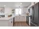 Beautiful kitchen featuring white cabinets, quartz countertops, stainless steel appliances and a bright window at 9306 Clermont Dr, Thornton, CO 80229