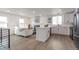A stylish open-concept living room and kitchen with modern finishes and ample natural light at 9306 Clermont Dr, Thornton, CO 80229