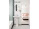 Stylish bathroom with mint tile, pedestal sink, and a glimpse into the connected bedroom at 1010 N Jasmine St, Denver, CO 80220