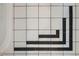 Close-up of elegant black and white bathroom tilework with a classic decorative pattern accenting the corner at 1010 N Jasmine St, Denver, CO 80220