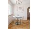 Cozy breakfast nook with a modern chandelier, clear chairs, and a round table set for a meal at 1010 N Jasmine St, Denver, CO 80220