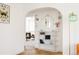 Charming entryway with arched doorway, decorative mirror, and built-in shelving at 1010 N Jasmine St, Denver, CO 80220