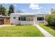 Unique home with flat roof, stucco siding, minimalist landscaping, and art deco design elements at 1010 N Jasmine St, Denver, CO 80220