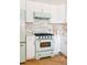 Charming kitchen featuring pastel appliances, herringbone floors, and stylish pastel backsplash at 1010 N Jasmine St, Denver, CO 80220