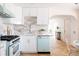 Bright kitchen with unique backsplash, retro-style appliances, and breakfast bar at 1010 N Jasmine St, Denver, CO 80220