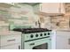 Close-up of a retro mint green oven with white countertops and colorful backsplash, evoking a vintage kitchen charm at 1010 N Jasmine St, Denver, CO 80220