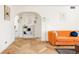 Inviting living room featuring hardwood floors, orange couch, and eye-catching décor at 1010 N Jasmine St, Denver, CO 80220