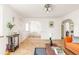 Spacious living room with hardwood flooring, arched doorway, and stylish decorations at 1010 N Jasmine St, Denver, CO 80220