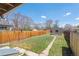 Well-maintained backyard featuring a lush lawn, wooden fence, and a storage shed at 4636 Leaf Ct, Denver, CO 80216