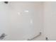 Updated shower and tub with updated shower head and grab rails, and clean white tile at 4636 Leaf Ct, Denver, CO 80216