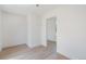 Cozy bedroom featuring wood floors, white walls, natural light, and a doorway at 4636 Leaf Ct, Denver, CO 80216