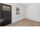 Bright entryway featuring light wood floors, white walls, and a black front door at 4636 Leaf Ct, Denver, CO 80216