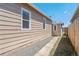 View of the side of the house and a partial view of the fence at 4636 Leaf Ct, Denver, CO 80216