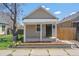 Charming exterior showcasing the tan siding, covered porch, and fresh landscaping at 4636 Leaf Ct, Denver, CO 80216