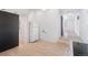 Bright kitchen features a refrigerator, adjacent laundry area, and a stylish sliding barn door at 4636 Leaf Ct, Denver, CO 80216
