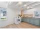 Updated kitchen boasts recessed lights, butcher block countertops, and updated appliances, with a view to the front yard at 4636 Leaf Ct, Denver, CO 80216