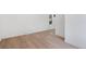 Bright living room with light wood floors, white walls, baseboard trim, and natural light at 4636 Leaf Ct, Denver, CO 80216