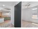 Open layout featuring a sliding barn door with a view of the updated kitchen at 4636 Leaf Ct, Denver, CO 80216