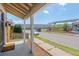 Inviting covered porch with mat and wood fence offers a view of the street and nearby park at 4636 Leaf Ct, Denver, CO 80216