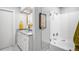 Bathroom featuring double vanity, walk-in shower, modern fixtures, and sleek design at 3206 S Clayton St, Denver, CO 80210