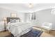 Cozy basement bedroom with neutral tones, lots of natural light, and a comfortable sitting area at 3206 S Clayton St, Denver, CO 80210