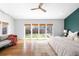 Bright bedroom boasts hardwood floors, neutral decor, and a large window overlooking the well-maintained backyard at 3206 S Clayton St, Denver, CO 80210