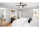Bedroom features a dedicated workspace, hardwood floors, and a ceiling fan at 3206 S Clayton St, Denver, CO 80210