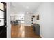 Inviting entryway with hardwood floors leads to a bright, open-concept kitchen and living area at 3206 S Clayton St, Denver, CO 80210