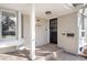 Inviting front porch featuring a decorative front door and a stylish lighting fixture at 3206 S Clayton St, Denver, CO 80210