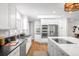 Well-lit kitchen with white cabinets, stainless steel appliances, and dark granite countertops at 3206 S Clayton St, Denver, CO 80210